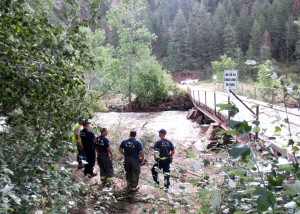 Firefighters standing at bridge stretching over the Poudre River at Gateway Park on Sept. 18. Photo Credit: Sarah Baker 