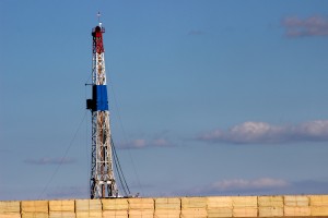 Fracking site off County Road 13, a wall built for sound control. The neighborhood HighPointe Estates is across from the site. Photo Credit: Chandler Gould