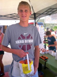 Photo Credit: Paige Closson Senior Andrew Semadeni sells peaches at the Peach Festival. 