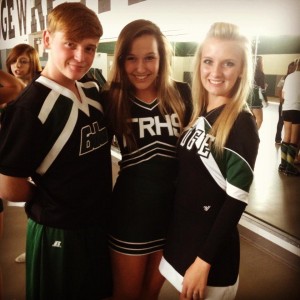 Andrew Conrad with Sydney Unger and Michaela Nylund during their junior year on the cheer team. 
