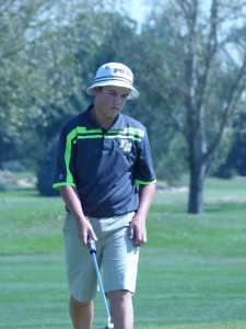 Freshman, Dillion Stewart concentrating on a putt.