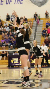 Freshmen Mataya Megson and Riley Zuhn block a hit from Collins. 