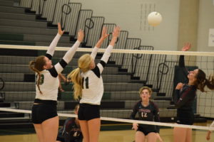 Courtney Isom and Tyler Lindgren go up for a block against opponent's offense. Photo Credit: Haley Rockwell
